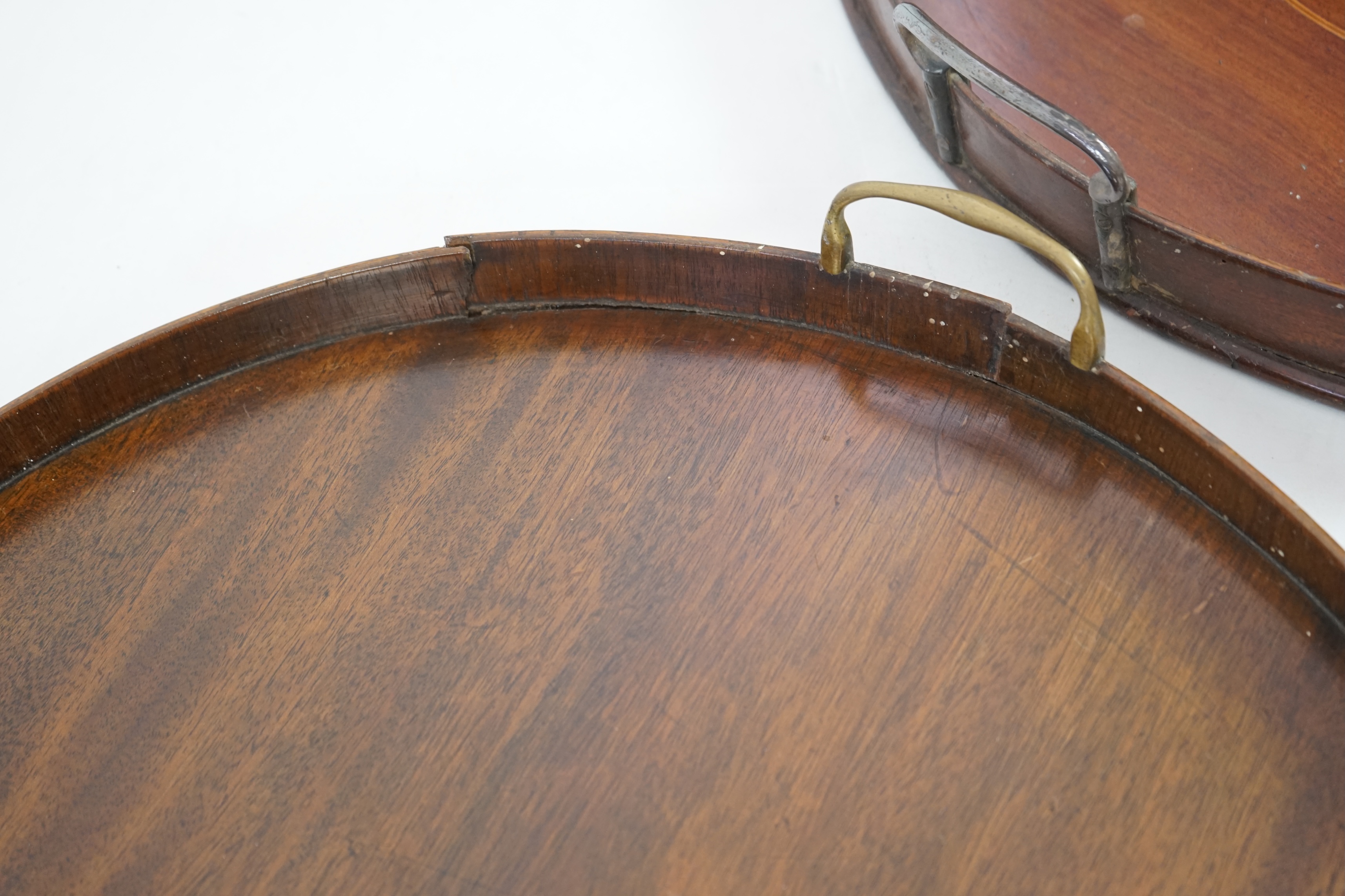 Three George III and later circular mahogany gallery trays